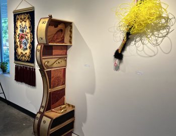 An art exhibit with a wooden box on display.