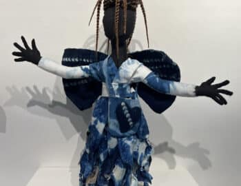 A doll with braids and blue dress.