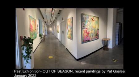 Interior of an art gallery with colorful paintings by pat goslee displayed on the walls of a softly lit hallway, taken in january 2022.